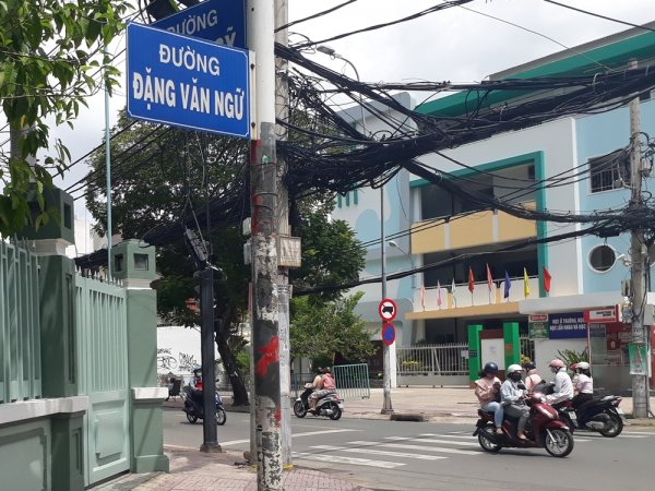 Vietnam corner street with people on moped